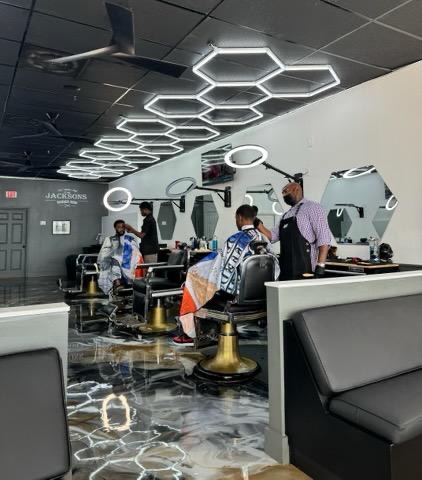 The clean, modern interior of Jacksons Barbershop — barber chairs and styling stations
